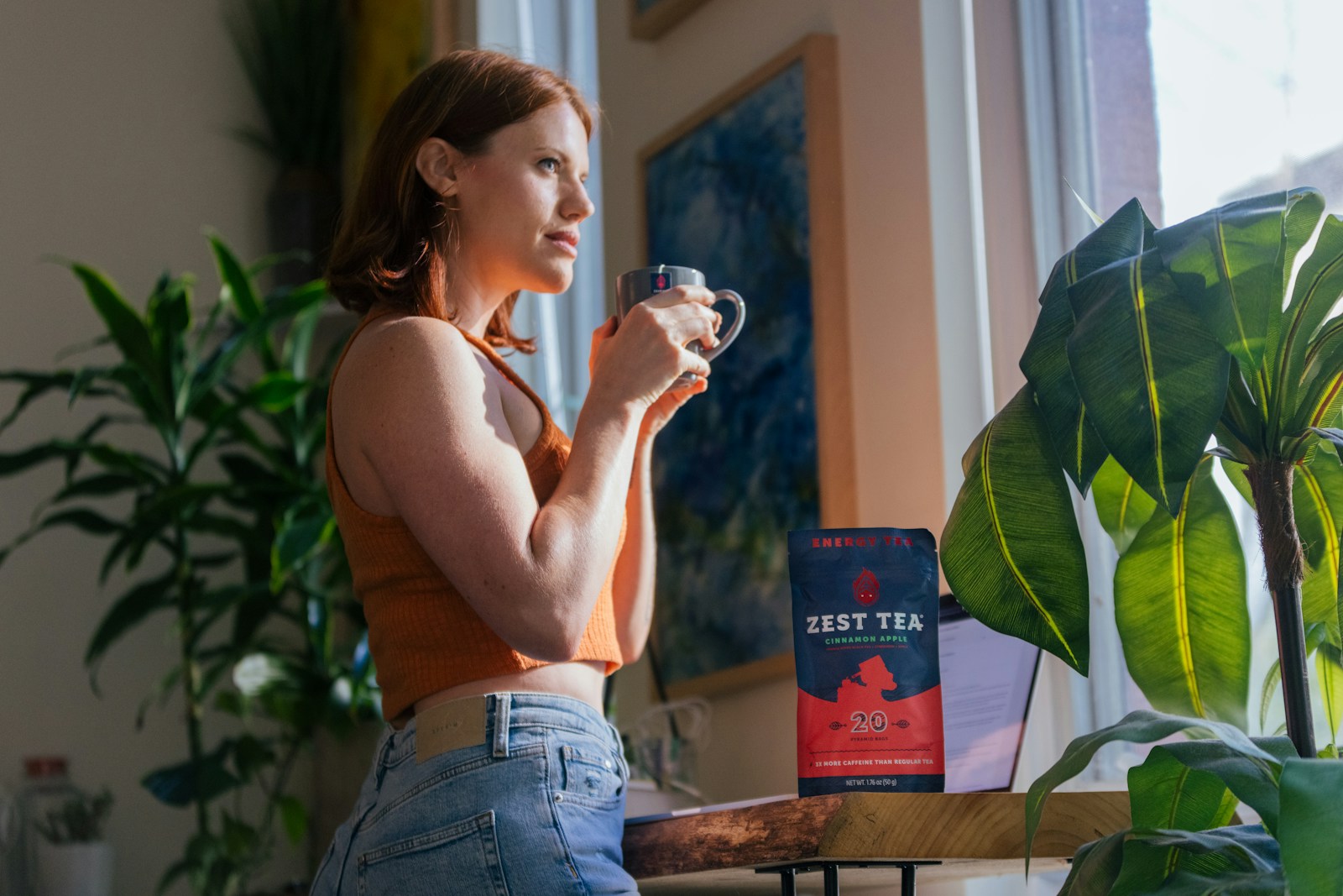 woman in blue denim shorts drinking from clear drinking glass