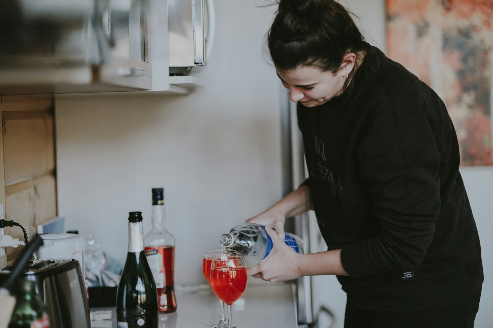 woman holding clear glass wine bottle photo